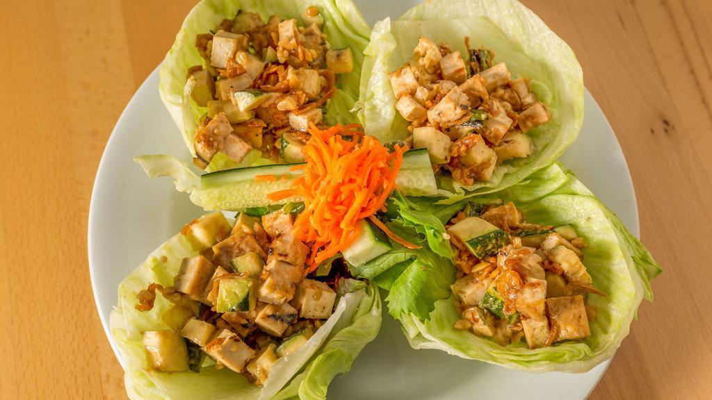 Tofu Lettuce Cups · Grilled tofu, diced zucchini, carrot, cucumber, chopped roasted peanut, crispy shallots, peanut sauces and served in lettuce cup.