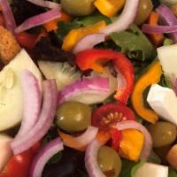 Not Your Average Salad · Fresh organic spring mix, cucumbers, red onions, tomatoes, red and yellow peppers, green oli...