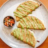 Quesadillas · Our cheese blend quesadillas with avocado crema and pico de gallo. With skirt steak or grill...