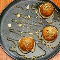 Fried Goat Cheese · With honey and cream of pistachios.