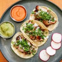 Carnitas Tacos · Slow cooked pork. Onions & cilantro