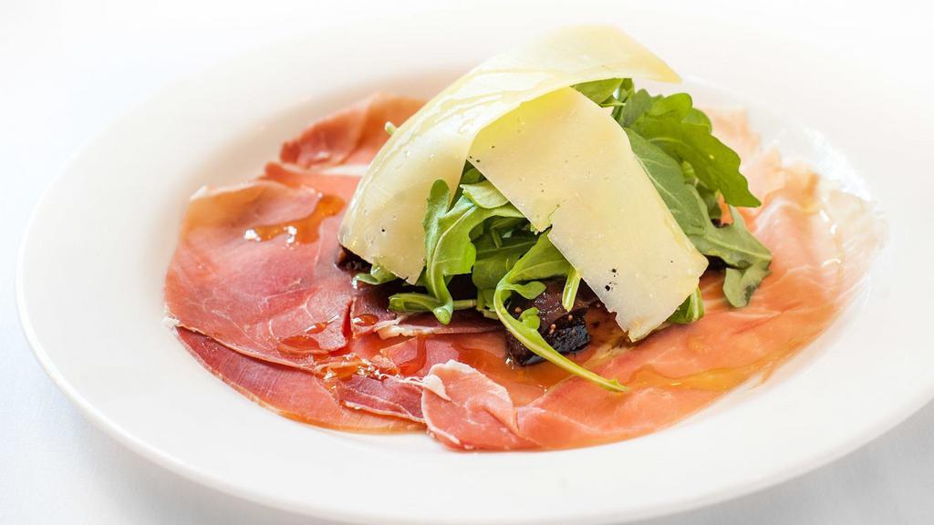 Prosciutto Di San Daniele · With figs and balsamic vinegar, topped with arugula and Parmigiano.