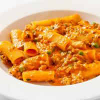 Rigatoni · With sweet fennel and spicy sausage, peas, and tomato cream.
