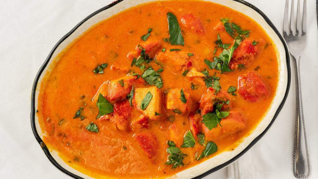 Chicken Tikka Masala · Pieces of chicken tikka cooked in a creamy sauce with fresh tomatoes and oriental spices.