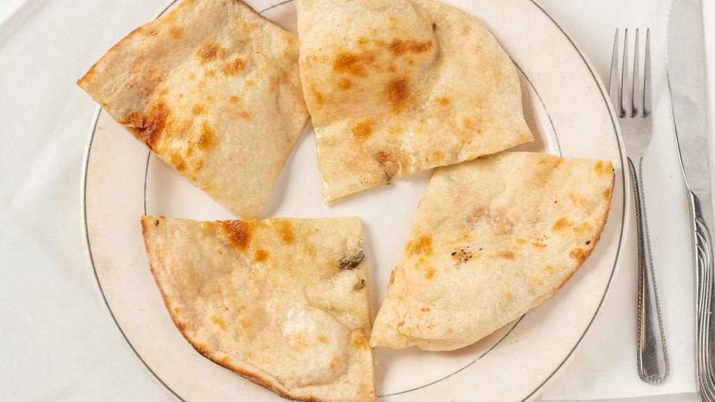 Naan · The traditional Punjabi white bread baked in tandoor with butter.