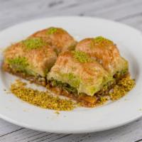 Baklava · Baked thin layered pastry filled with roasted chopped walnuts, flavored with honey syrup and...