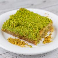 Kadayif · Baked shredded wheat filled with walnuts flavored with honey syrup, garnished with pistachios.