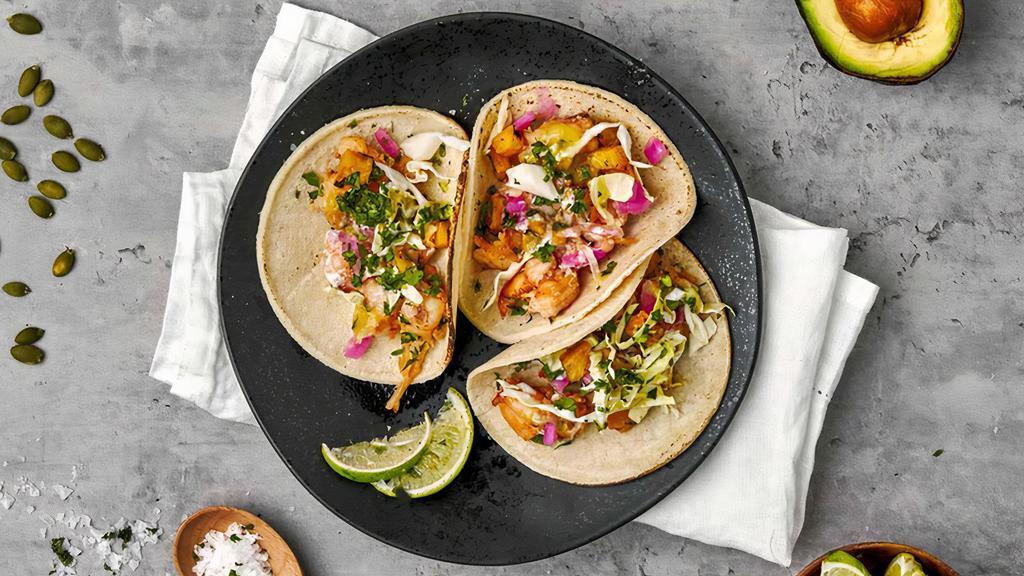 Salt & Pepper Shrimp Taco · Create your Ajo Shrimp taco with simply seasoned shrimp, your choice of Tributo toppings and two sauces | Allergen: Crustacean Shellfish, Wheat