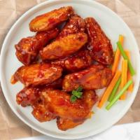 Bully Buffalo Chicken Wings · Fresh chicken wings breaded, fried until golden brown, and tossed in buffalo sauce. Served w...