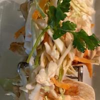 Baja Fish Tacos · Four mini tacos. Crispy hake, cumin-honey slaw, chipotle aioli.