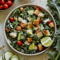 Kale Chicken Caesar · Classic Caesar dressing, curly kale, roasted chicken, grape tomatoes, cucumbers, herbed foca...