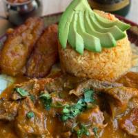 Seco De Chivo · GLUTEN FREE.Goat stewed in Naranilla* and cilantro. Served with yellow rice, sweet plantains...