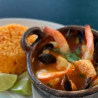 Sudado Mixto · Octopus, Mussels, fish and shrimp in cilantro and tomato sauce. Yellow rice