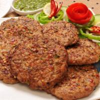 Chapli Kebab · Ground chicken marinated in Indian spices and pan fried.