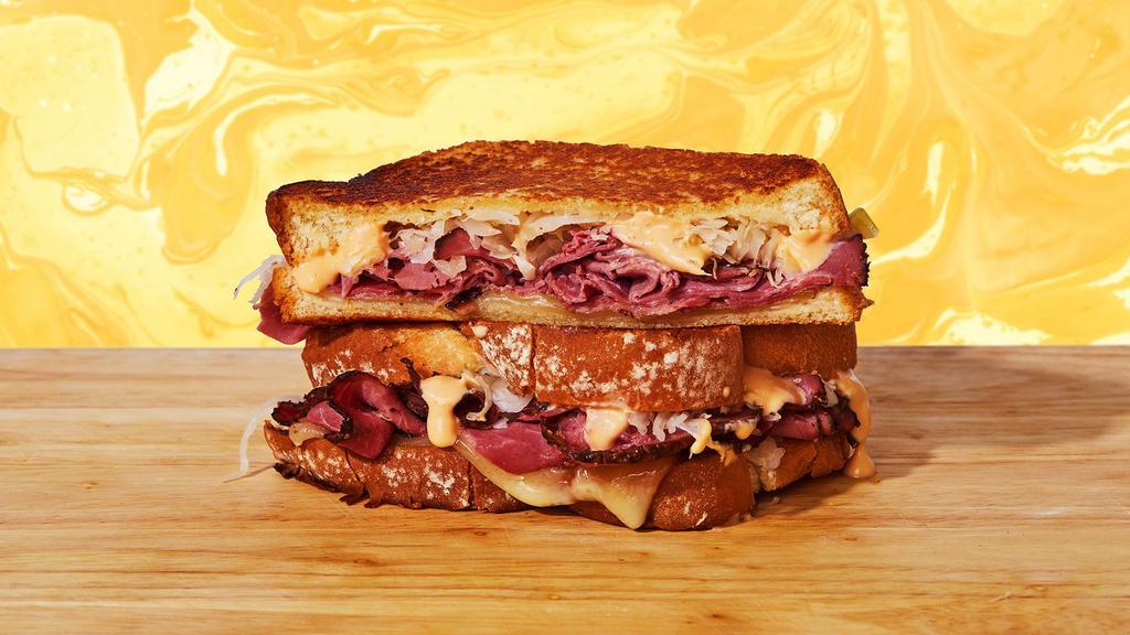 Reuben Grilled Cheese · Melted swiss cheese, juicy pastrami meat, tangy sauerkraut, and Thousand Island dressing between two slices of buttery grilled bread.