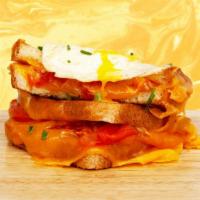 Breakfast Grilled Cheese · Melted cheddar, egg, and tomato between two slices of buttery grilled bread.