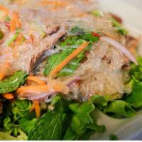 Yum Woon Sen · Long rice noodle salad with carrot, onion, mint, cilantro and lettuce.