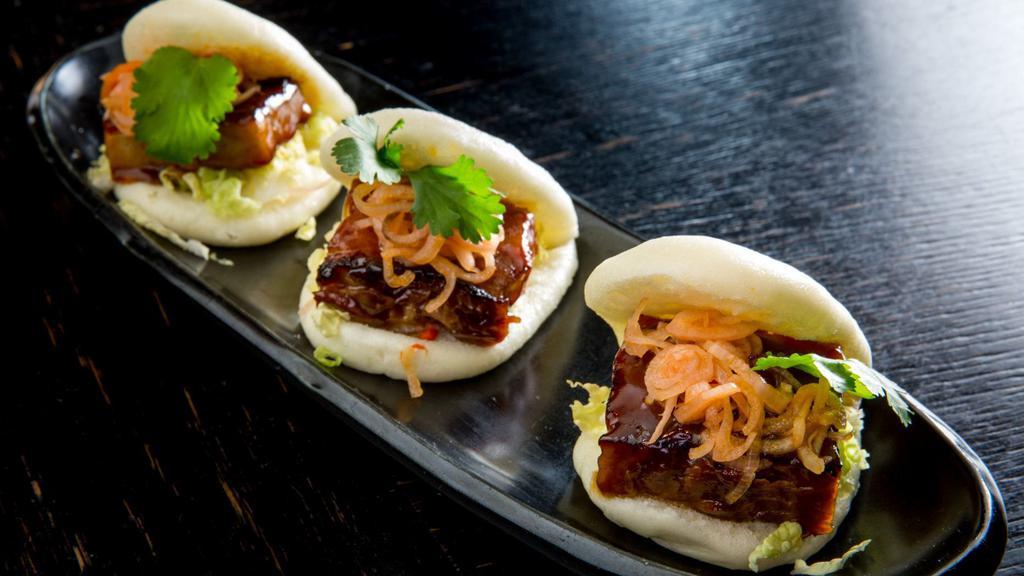 Pork Buns · Charred pork belly, spicy shallots and napa cabbage. Hot.