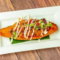 Platano Relleno · Sweet plantain stuffed with show roasted pork, drizzled with sour cream.