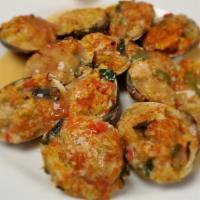 Clams Casino · Stuffed with bacon, onions, peppers, and leeks in a lemon butter sauce.