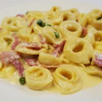 Tortellini Carbonara · Served with prosciutto e peas in a cream sauce.