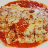 Veal Parmigiana · Breaded veal cutlet topped with marinara, and mozzarella cheese.