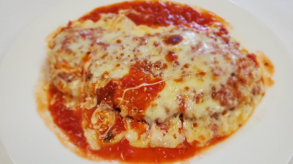 Veal Parmigiana · Breaded veal cutlet topped with marinara, and mozzarella cheese.