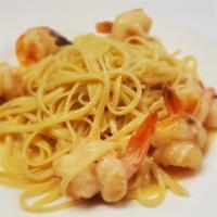 Shrimp Scampi · Served over linguine.