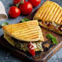 Ala Pesto Panini · Grilled Panini Sandwich made with European Flatbread and topped with Chicken breast, fresh m...