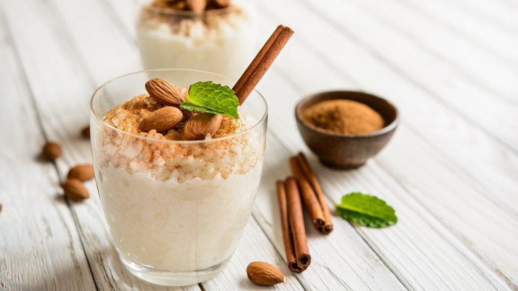 Rice Pudding · A delicious serving of rice pudding mixed with cinnamon, vanilla, and raisins.