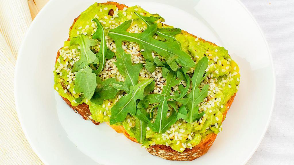 Avocado Toast · Topped with arugula, drizzled with olive oil, with a sprinkle of sesame seeds served on multi grain bread.