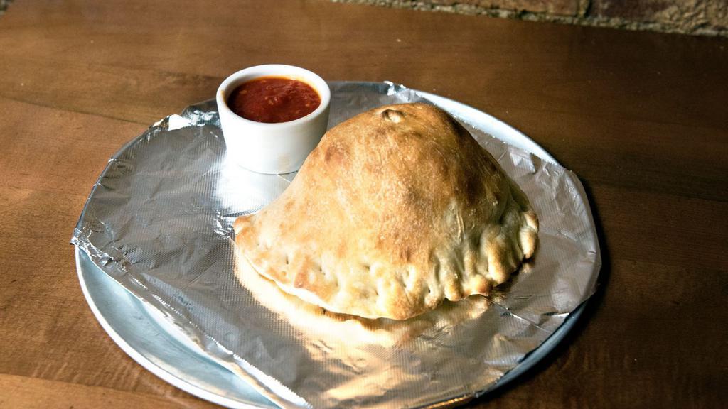 Spinach Pie Calzone · Calzone filled with mozzarella cheese, spinach, pepperoni and roasted garlic.