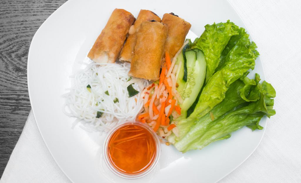 Spring Rolls · A vietnamese deep-fried egg roll filled with ground pork chicken carrots onion long rice and taro. served with a plate of lettuce slices of cucumber rice noodles and our exceptional dipping sauce.