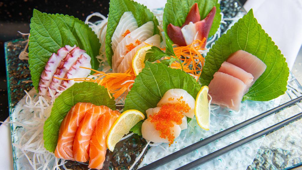 Sashimi Deluxe · Twenty pieces of assorted sashimi and rice. Served with clear or miso soup and salad.