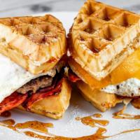 Brekkie Waffle Sliders · Fried eggs, turkey bacon, turkey sausage, cheddar, hot honey drizzle, served on waffle, mapl...