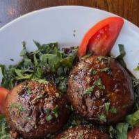 Portobello Mushrooms · Sautéed with balsamic vinegar over spinach.