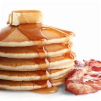 Pancakes With Bacon · Fluffy pancakes and bacon served with a side of butter and syrup.