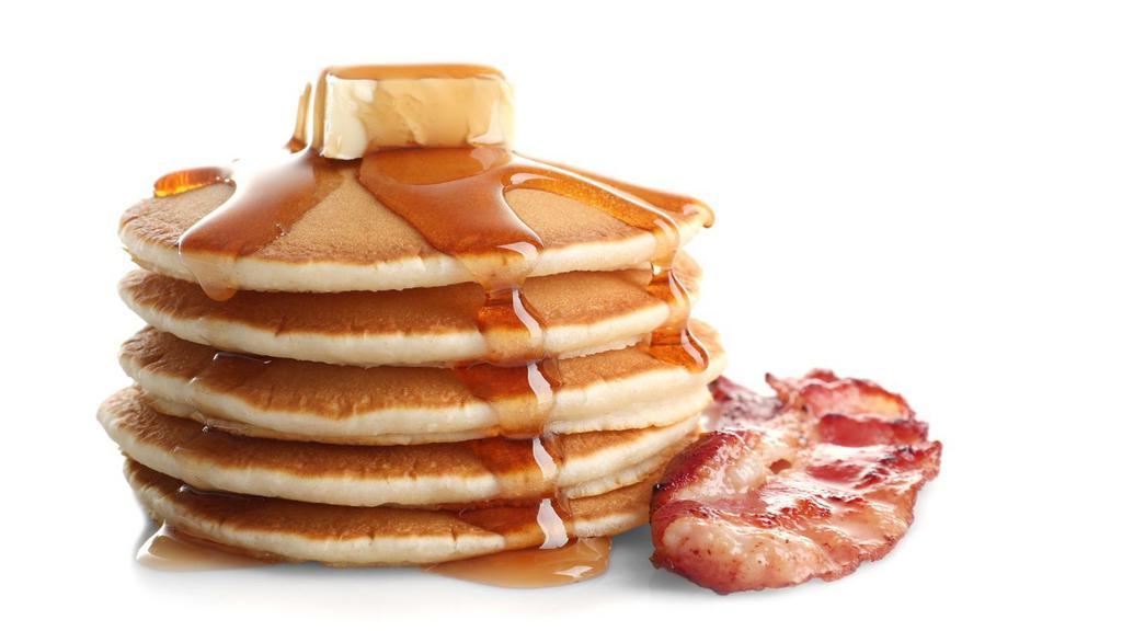 Pancakes With Bacon · Fluffy pancakes and bacon served with a side of butter and syrup.