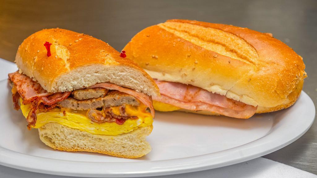Hungry Man · 3 eggs with bacon, ham, sausage, and cheese on a hero.