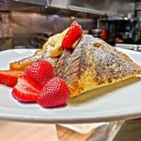 French Toast · Topped with strawberry and banana,  and powdered sugar