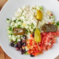 Greek Salad · Iceberg lettuce, tomatoes, cucumbers, peppers, feta cheese greek olives, onions, stuffed gra...
