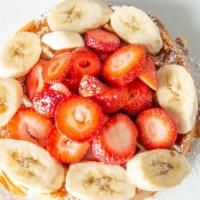 Belgian Waffle With Fresh Strawberries And Bananas · Belgian waffle with fresh strawberries and bananas.