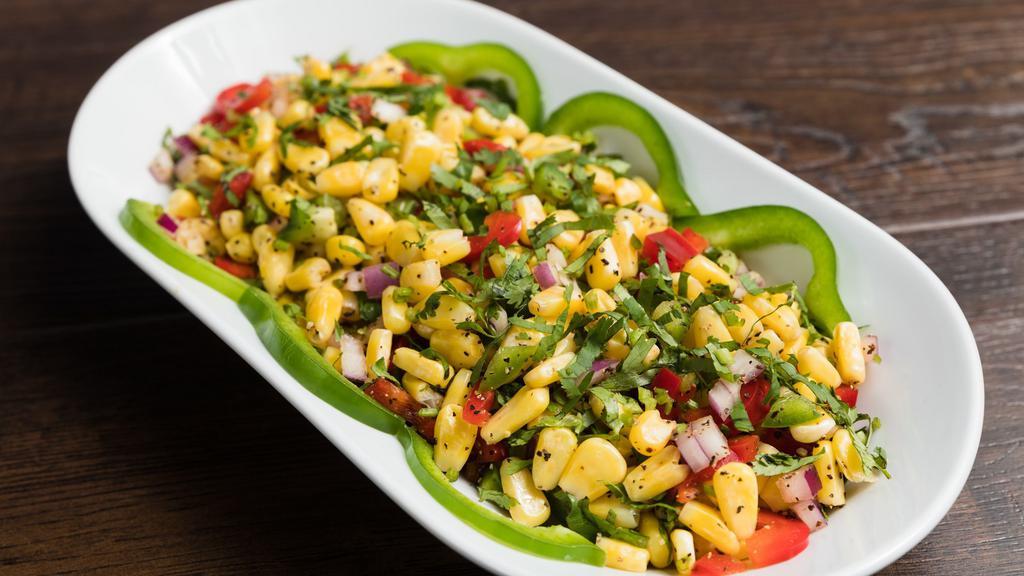 Spicy Corn · Spicy. Sauteed corn with fresh tomatoes, onion and peanut spicy dressing.