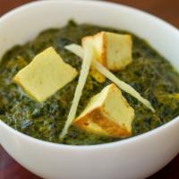 Saag Paneer · Spinach cooked with cheese cubes and seasoned with freshly grounded herbs.