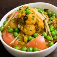 Aloo Matar Gobi · Potatoes and peas with cauliflower cumin spices.