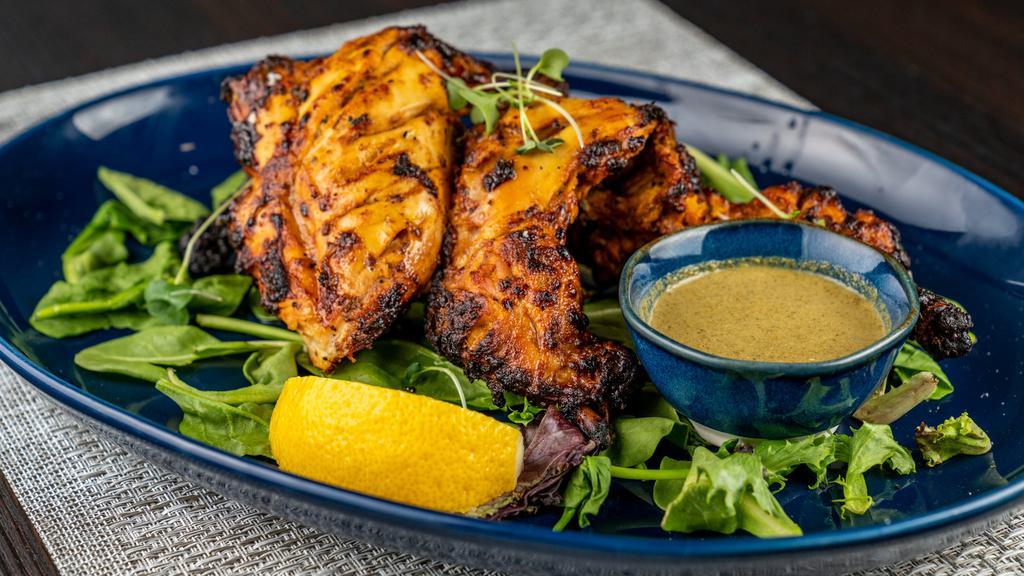 Tandoori Cornish Hen - Whole · Classic Cornish Hen marinated overnight in yogurt lemon juice, carom seeds, exotic spices with ginger, garlic & cooked to perfection in a clay oven. Served with Mint Pomegranate Chutney