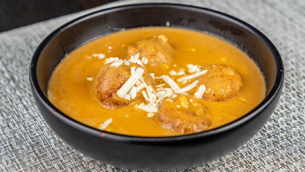 Malai Kofta · Spongy Cottage Cheese Mashed with cashew nuts, raisin, rolled into balls and cooked in a mildly spiced nut & cream gravy with saffron and green cardamom.