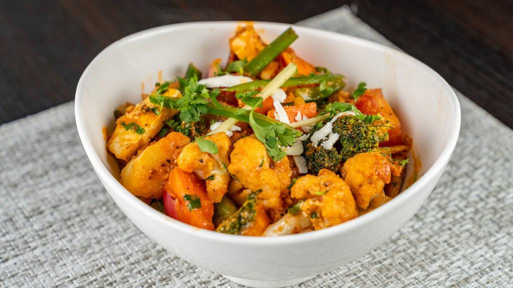 Veg Jalfrezi · Assorted vegetables sautéed with diced paneer, sweet peppers, red onions, tomatoes and exotic spices.