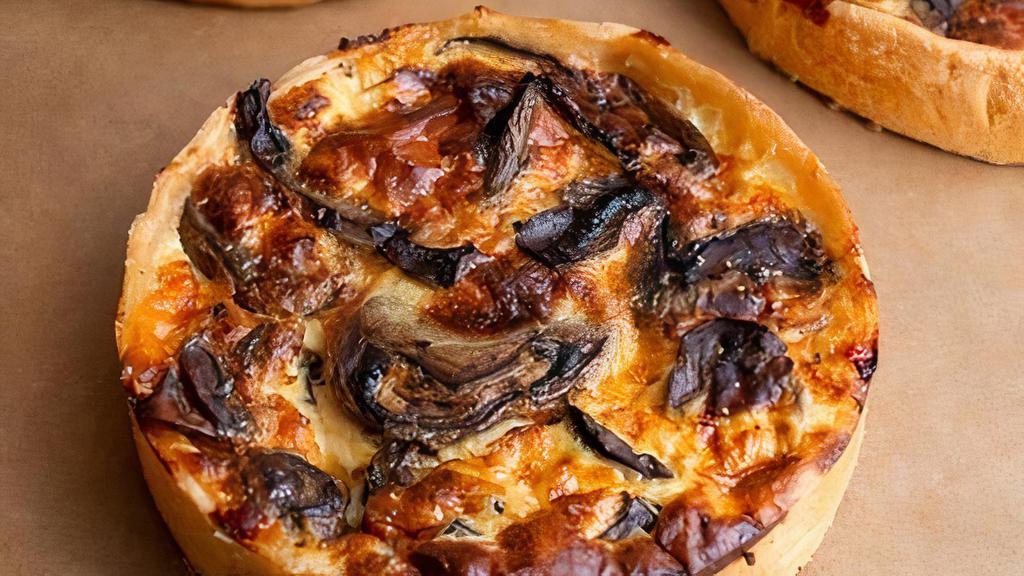 Mushroom Quiche · Flaky savory tart with mushrooms, onion, and gouda cheese.
