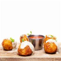 Mac & Cheese Bites · Creamy five cheese mac and cheese bites with pieces of bacon and finished with Maytag aioli.